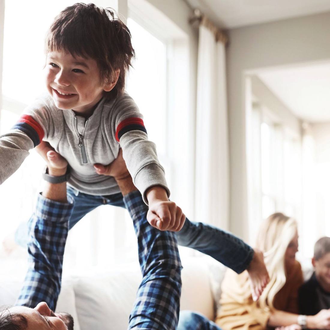 Child playing with parent at home